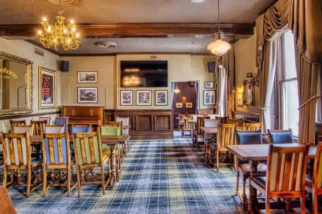 Upstairs function room with wood accents for intimate networking and team workshops.