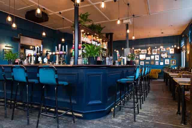 Upstairs function room with deep-blue decor, perfect for corporate receptions and networking events.