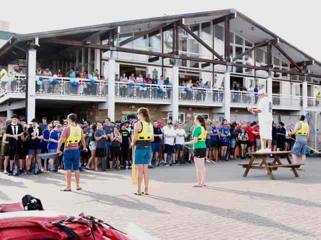 Unsafe outdoor site briefing at Docklands Sailing Centre on a picnic table stage.
