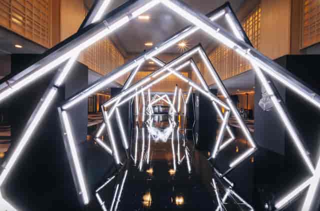 Futuristic immersive tunnel entrance for tech summit or gala event venue.