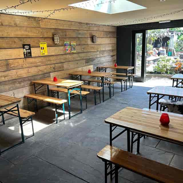 Upstairs function room with rustic bench seating for networking events and team building socials.