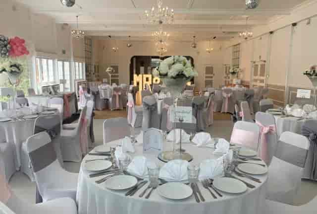 Wedding reception setup in Club Langley featuring elegant floral centerpieces and table decor.