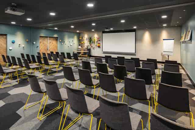Bank Suite theater-style meeting space with AV projection, perfect for corporate events and seminars.