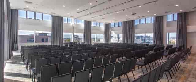 Theater-style conference room with natural light, perfect for business meetings and presentations.