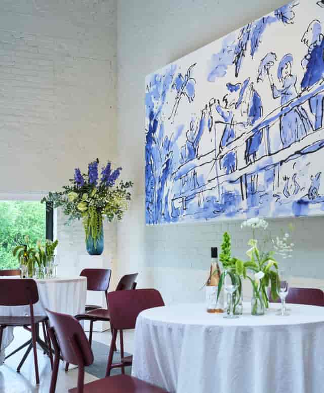 Boiler House Cafe event space with mural art and floral decor for corporate receptions.