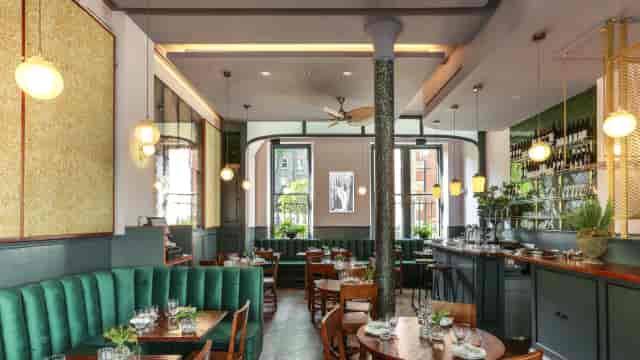 High-end restaurant space with banquette seating for corporate dinners and networking mixers.