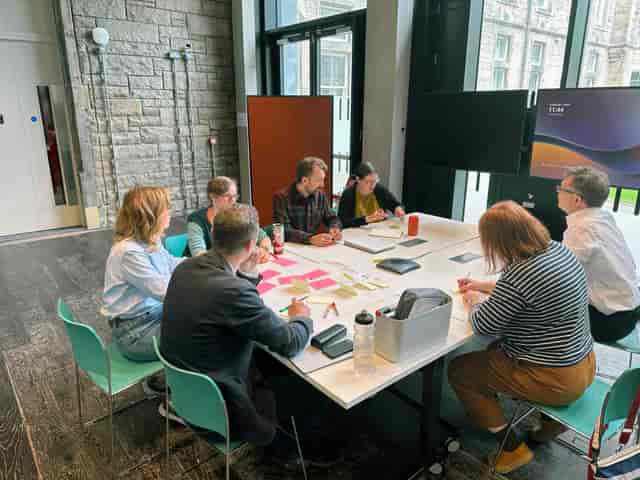 Collaborative boardroom brainstorming session with whiteboard for corporate training events.