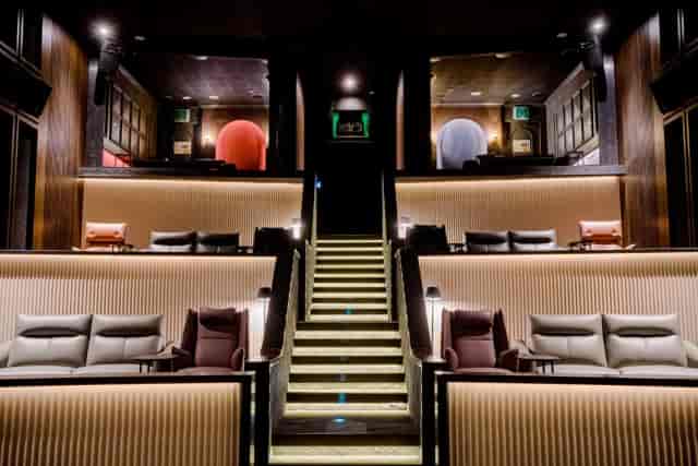 Luxury boutique screening room with tiered lounge seating for executive retreats and product launches.