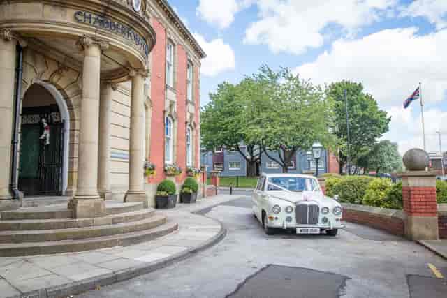 Grand wedding arrival at historic Chadderton Town Hall register office venue.