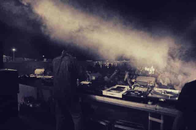 DJ booth at W London evening reception with atmospheric stage lighting for corporate events.
