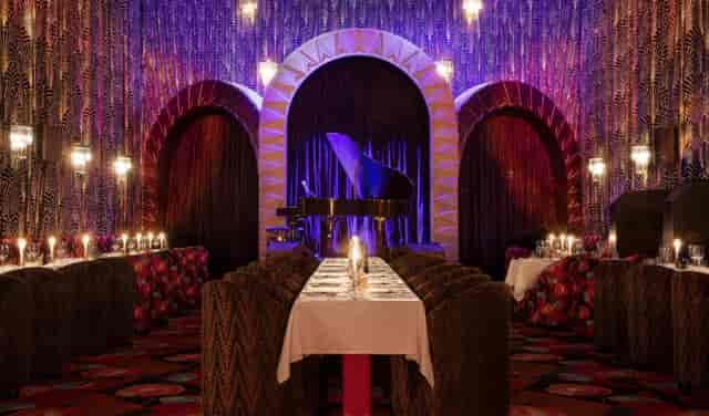 Itzel Club gala: arched stage with dramatic lighting for VIP dinners and corporate showcases.