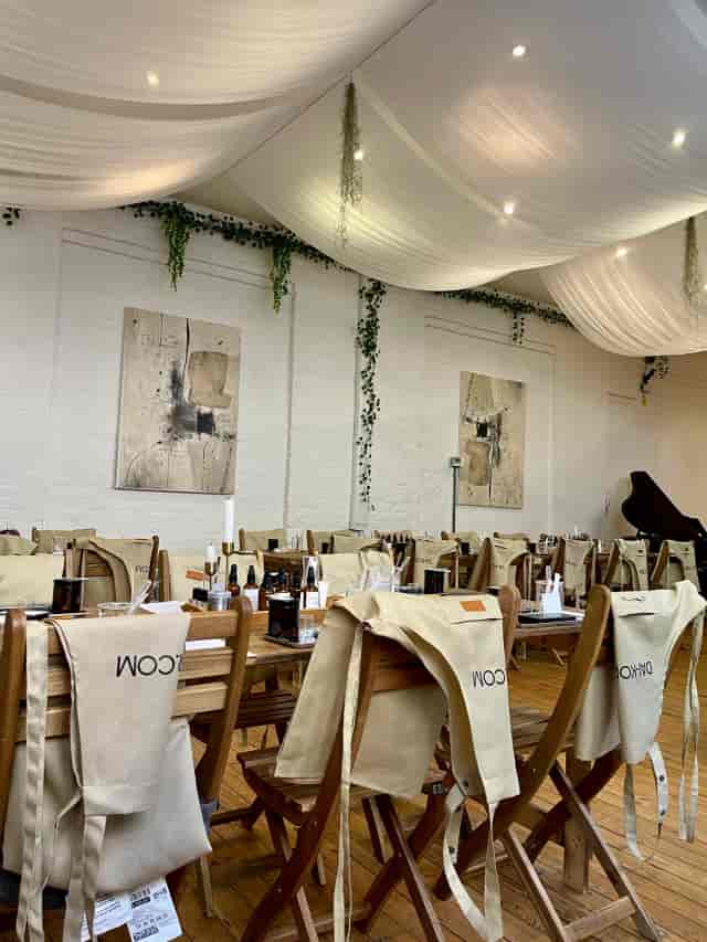 Whole Studio event space with soft ceiling drapes for corporate workshops and boutique gatherings.