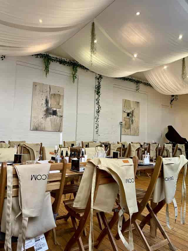 Boutique event space with elegant drapery, perfect for intimate workshops and private dining.