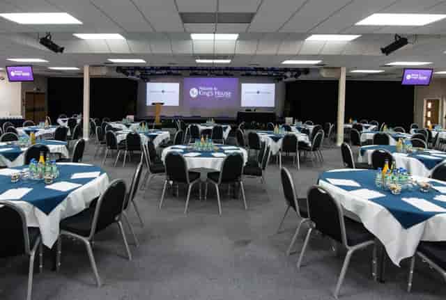 Kings Hall College banquet room with round tables, ideal for seminars and corporate conferences.