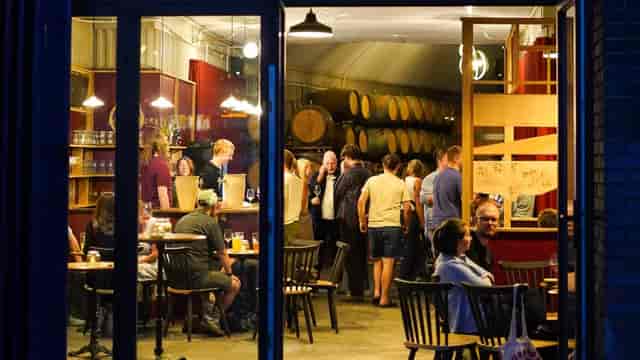 Rustic industrial taproom at Cloudwater Brewery, ideal for corporate networking and events.