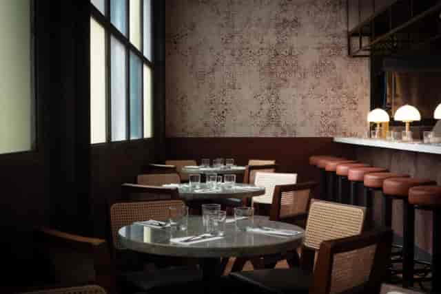 Sophisticated dining room with round tables for boutique private events and networking.