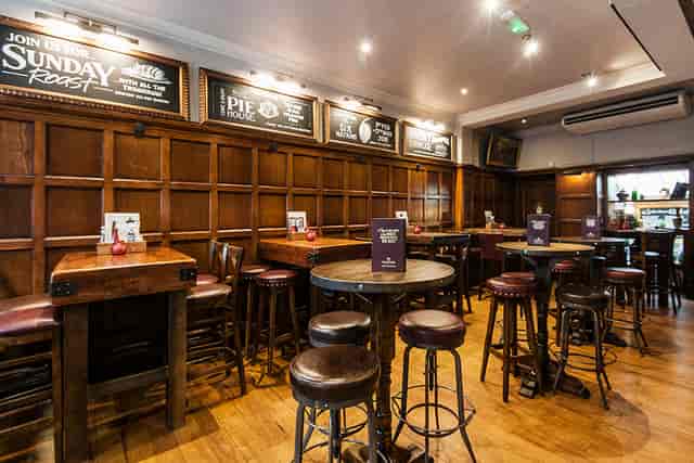 The Parlour at The White Horse: high-top tables for networking events and team socials.