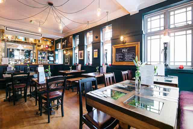 The Conservatory pub space for corporate mixers and team lunches with warm, authentic decor.