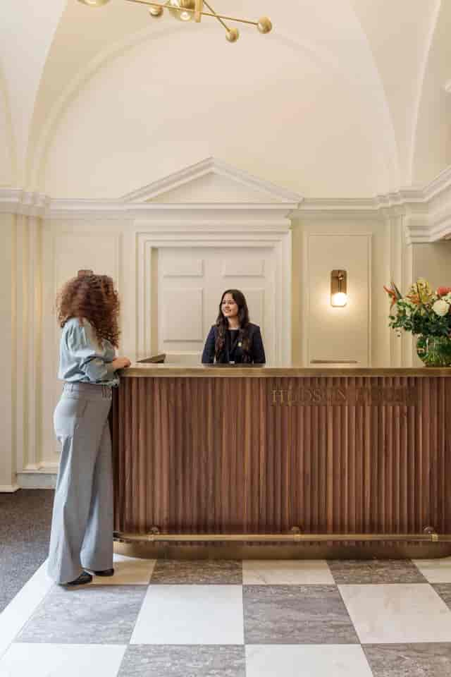 Guest services representative providing premium hospitality at a Hudson House event venue.