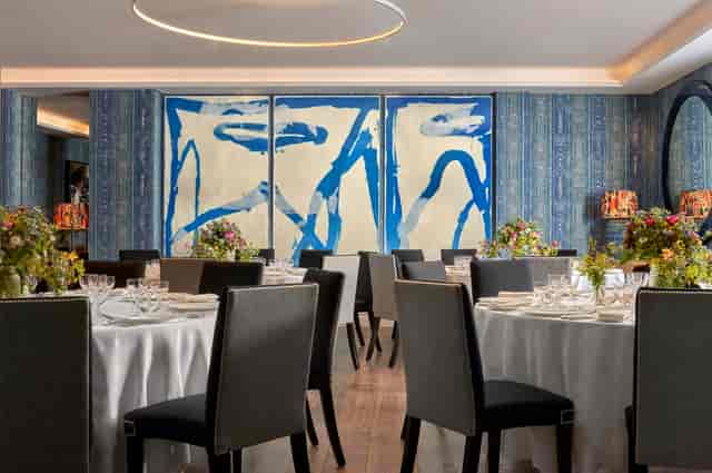 The Indigo Room boutique venue with round-table banquet seating for corporate dinner events.