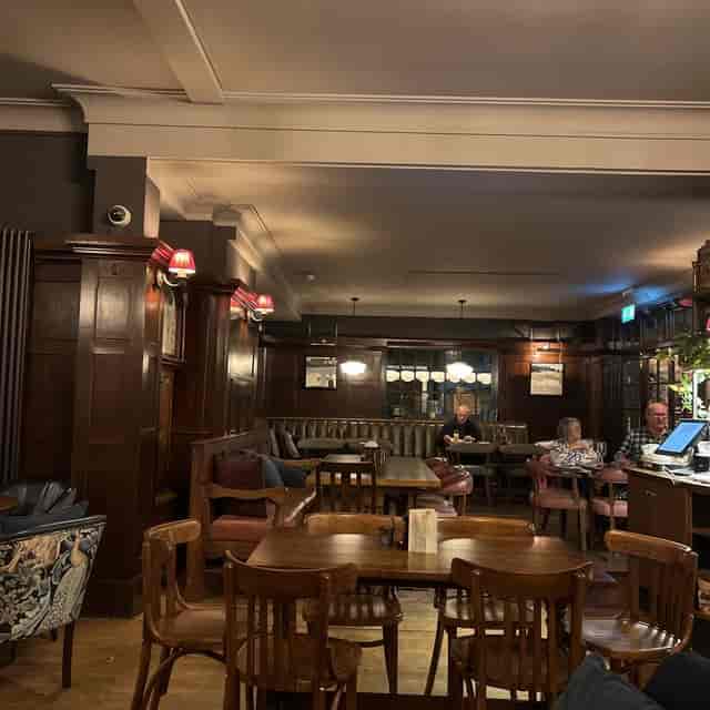 Cozy wood-paneled gastropub at The Barley Mow, ideal for intimate networking and team socials.