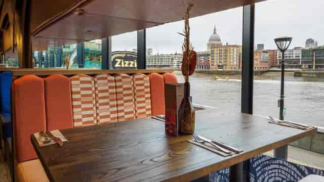 Zizzi Bankside group dining area overlooking Thames and St. Paul's for corporate lunch events.
