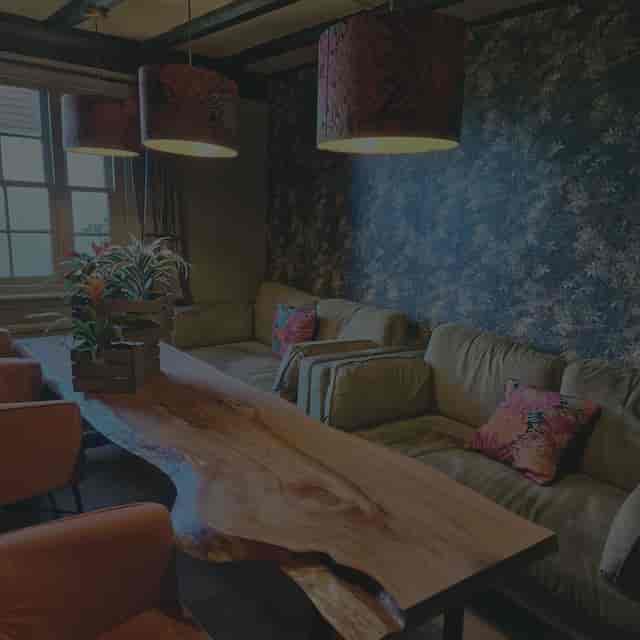 Raw-edge wood table in Tottington Manor breakout space for creative workshops and board meetings.