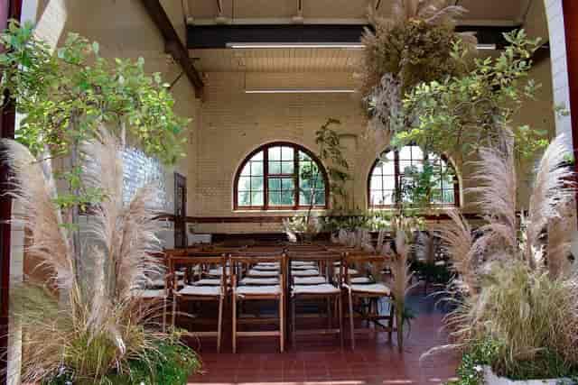 Industrial wedding venue at Buoy Store London with organic floral decor for intimate ceremonies.