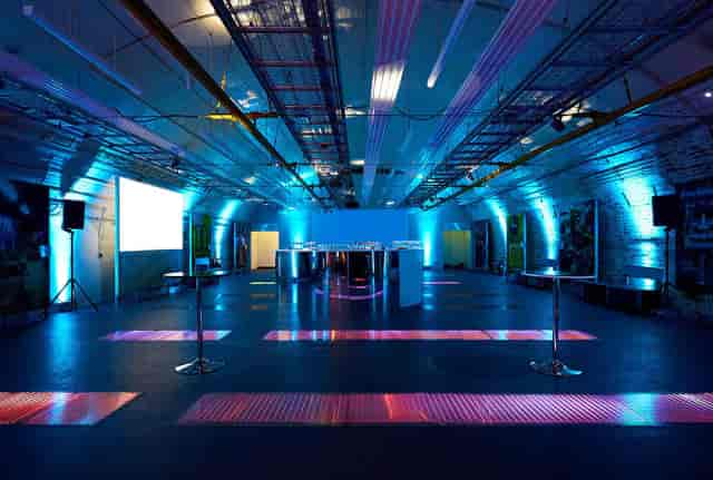 Buoy Store London warehouse: industrial venue with vibrant event lighting for product launches.