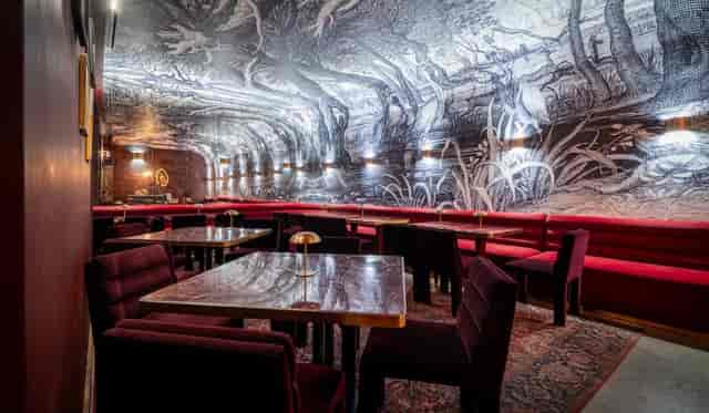 Red Arch main room venue for intimate networking and VIP dinners with immersive aesthetic.