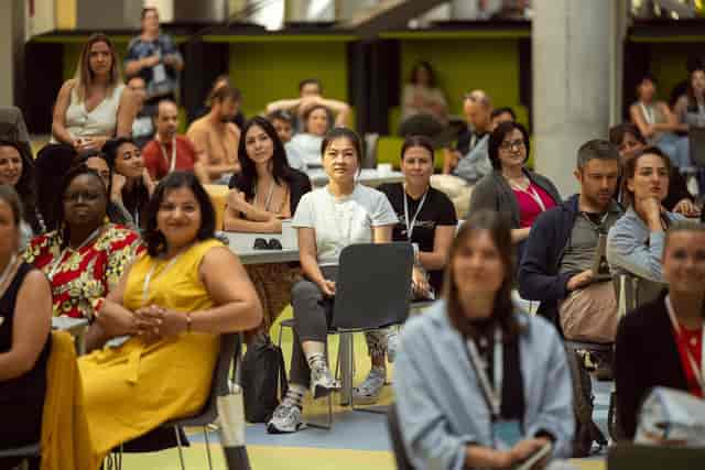 Diverse audience networking at an Impact Hub Bucharest professional conference breakout session.