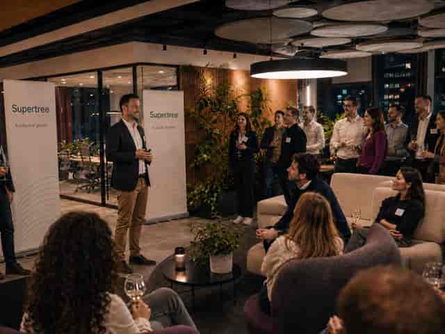 Corporate networking event in a modern lounge with branded banners at Impact Hub Bucharest.