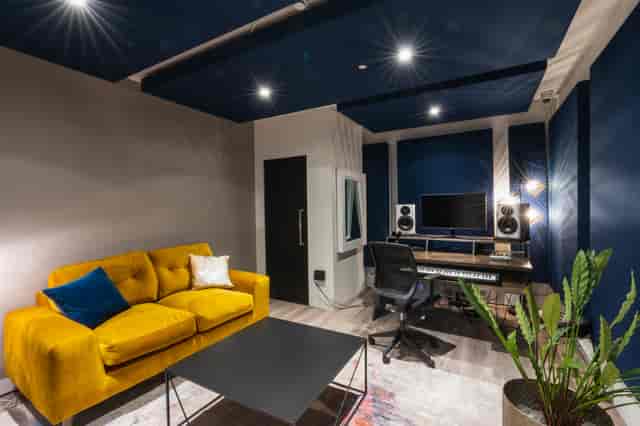 Podcast studio suite with acoustic panels for professional podcast recording and VIP meetings.