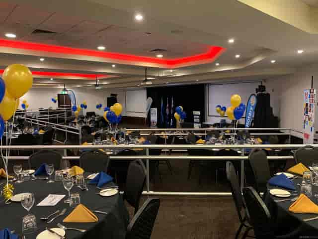 Oriana Room gala banquet setup with blue-and-gold balloons for a corporate event.