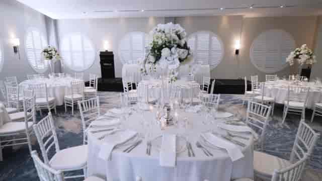 Grand Ballroom banquet setup with floral centerpieces for corporate galas and wedding receptions.