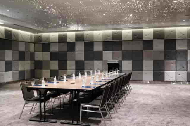 Grand Ballroom boardroom with sleek table and acoustic walls for executive meetings and events.