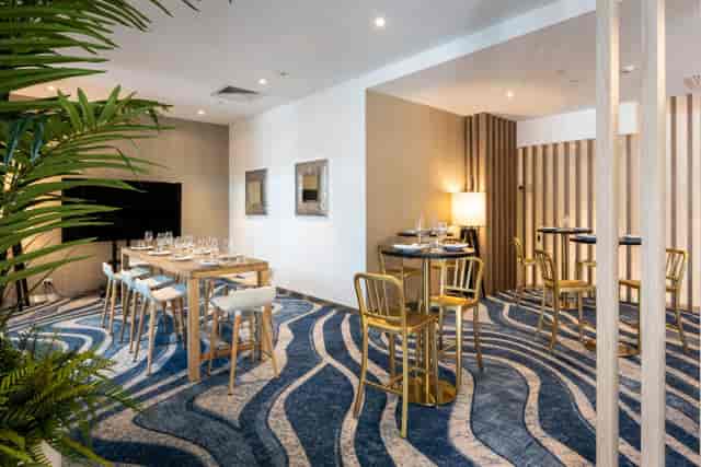 Modern breakout space with high-top seating for corporate events and networking meetings.