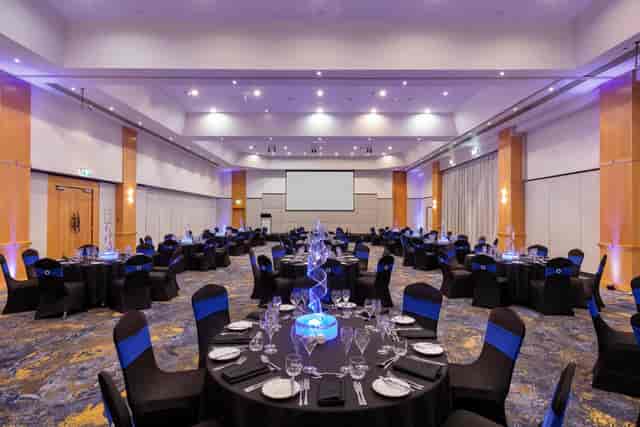Novotel Surfers Paradise grand ballroom with blue lighting for corporate dinners and awards nights.