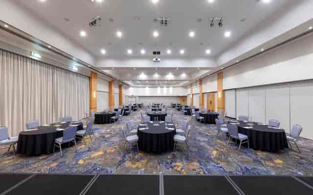 Grand Ballroom with round tables for corporate conferences and formal events.
