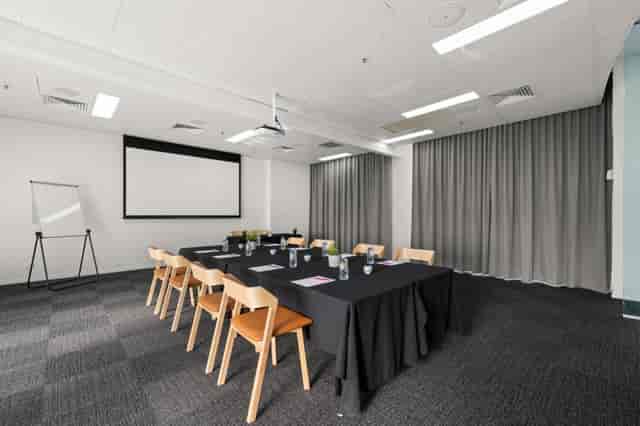 Wavebreak boardroom with projector and whiteboard for corporate meetings and workshops.