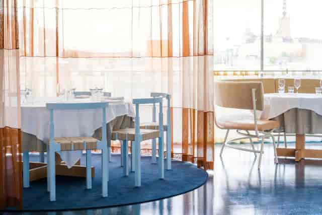 Upscale corporate lunch venue at Hotel Esplanade with elegant linen tables and city views.