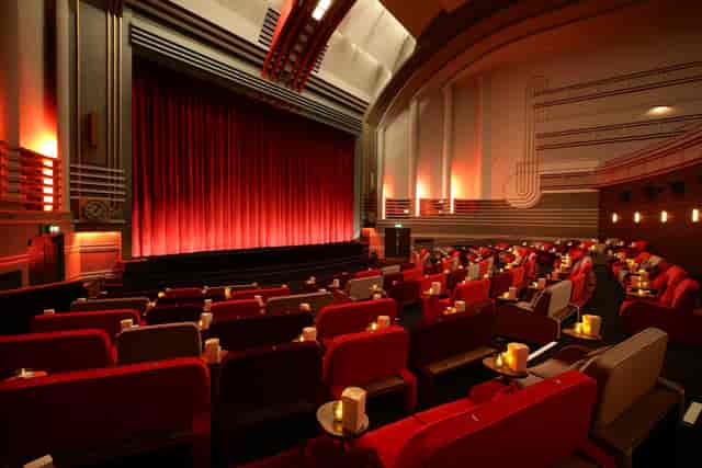 Art Deco theater screen with plush seating for VIP presentations and film premieres.