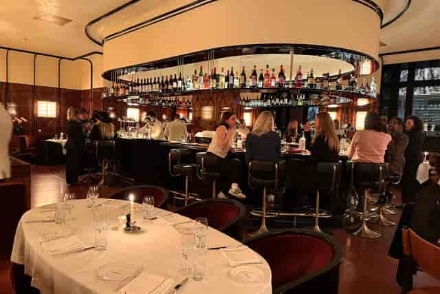 Manhattan Grill oval bar: intimate corporate reception and formal networking event space.