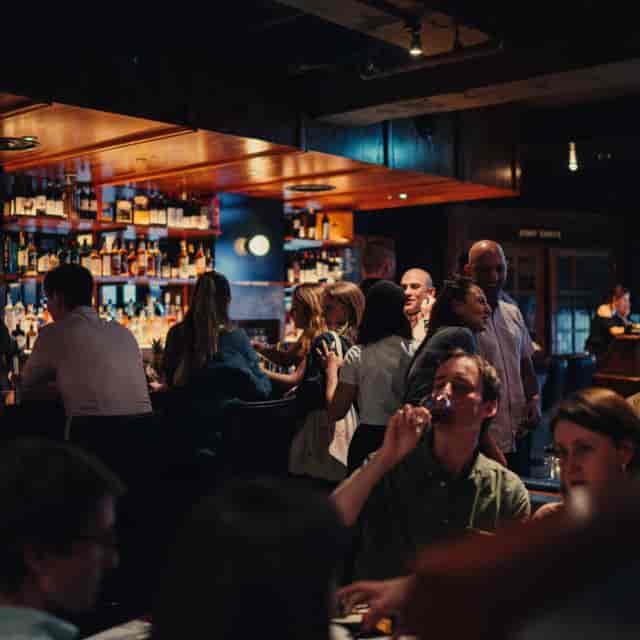 Networking reception at Manhattan Grill featuring intimate, low-light evening event ambiance.