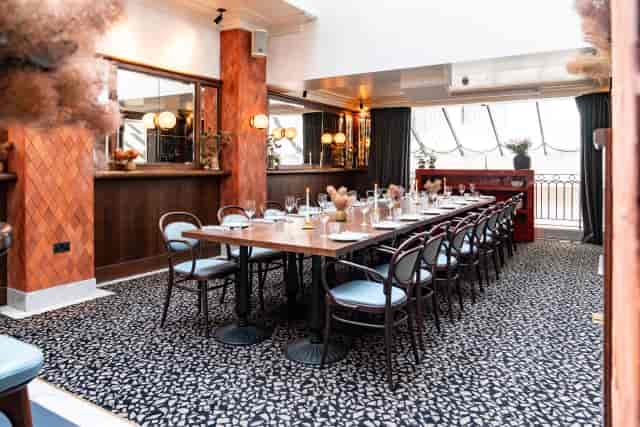 Private dining room at The Mezzanine, warm interiors for corporate dinners and board meetings.