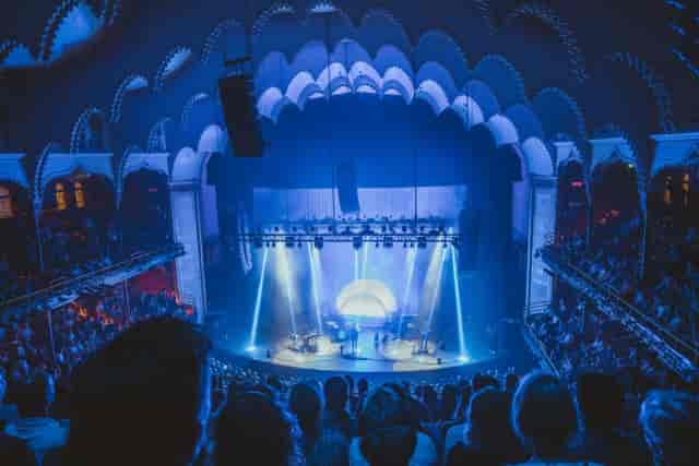The Violin Factory stage production with cool-toned lighting for corporate event venue hire.