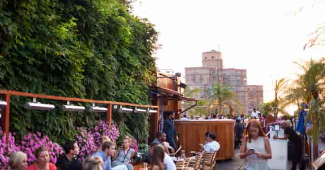 Rooftop deck with lush living wall for networking receptions and cocktail events.