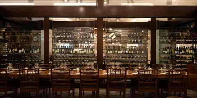 Salon North private dining room with illuminated wine cellar for corporate events and galas.