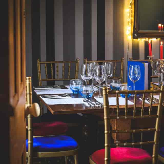 Private dining room with gold chairs for upscale corporate dinners and wedding receptions.
