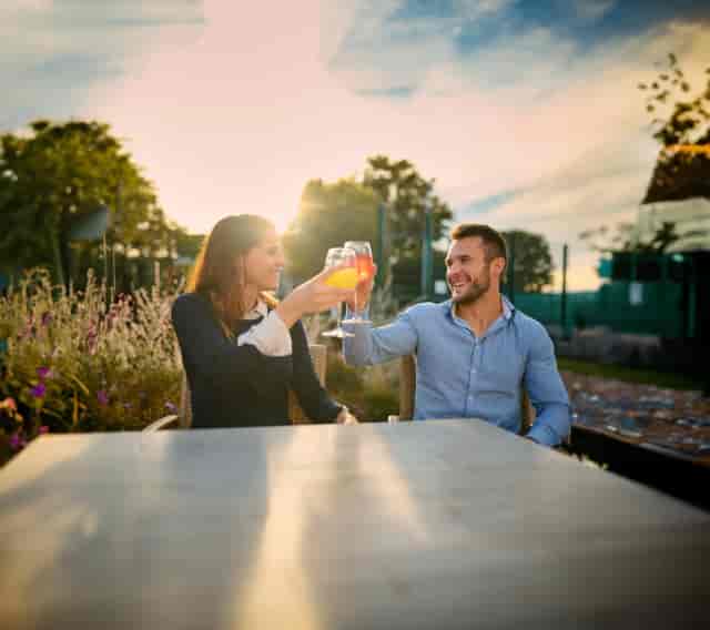 Outdoor networking reception on David Lloyd Oxford terrace at golden hour.